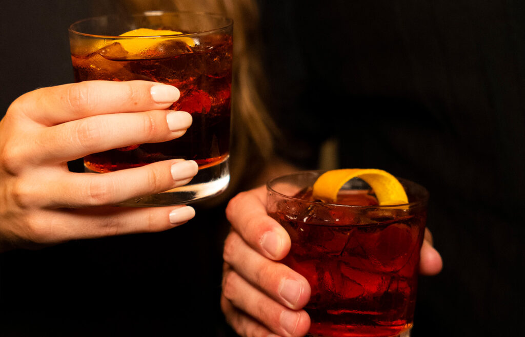 two cocktails in hands